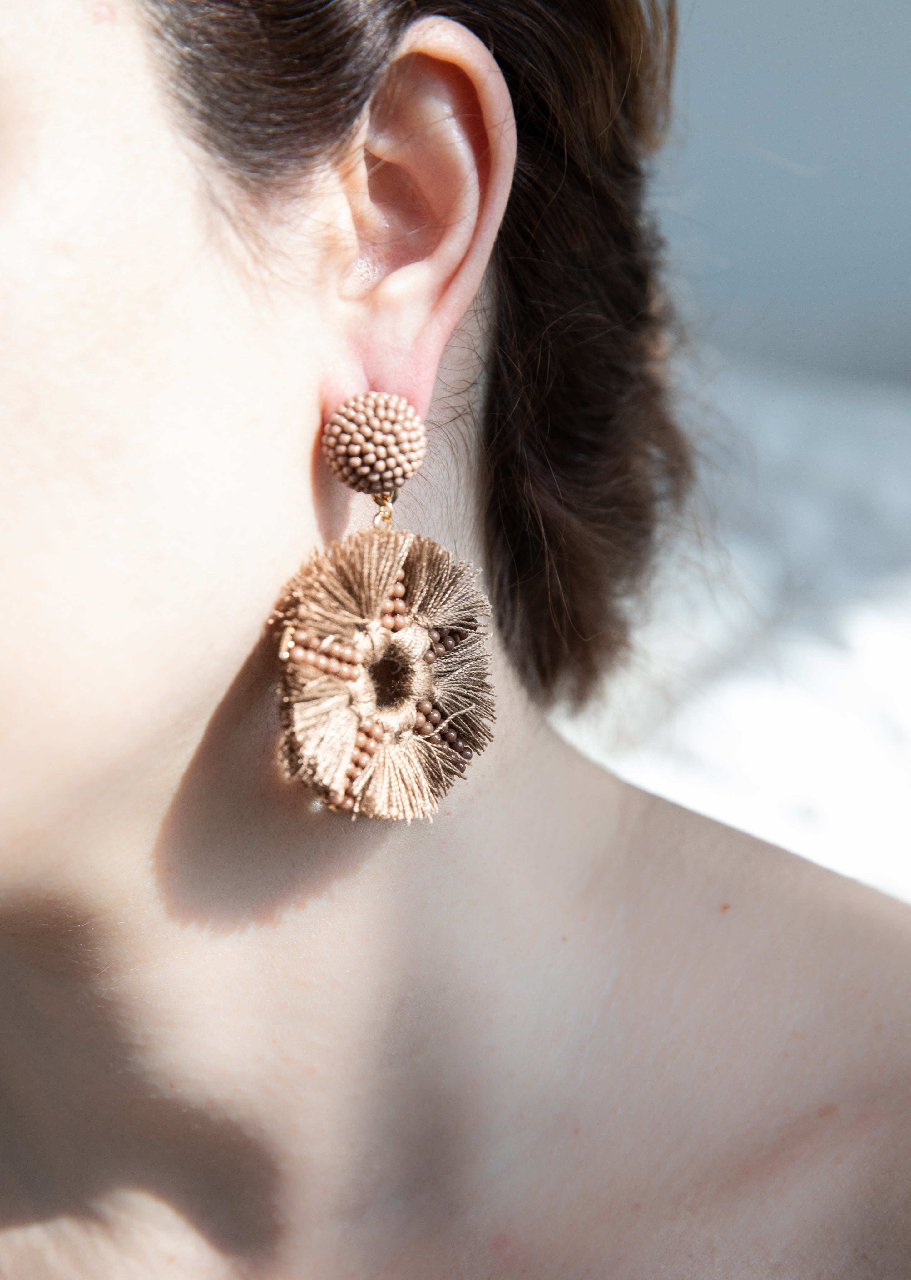 files/ear-close-up-with-a-light-brown-statement-earring.jpg